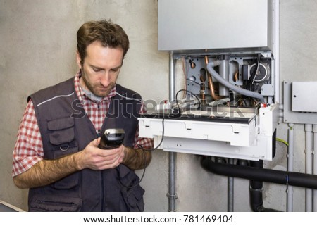 plumber repairing a condensing boiler