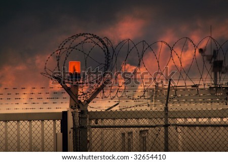 the barbed wire with clouds and light
