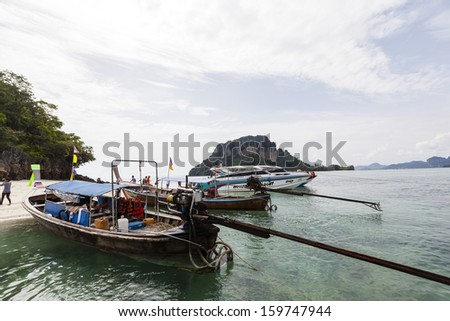 KRABI, THAILAND - JULY 7 : Unidentified boat driver and shuttle service longtail boat ride for the tourists to the islands on July 7,2013 in Krabi ,Thailand.