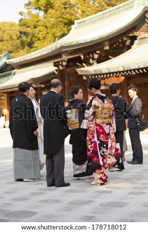 TOKYO, JAPAN - NOV 11: Japanese people dress up in formal for a celebration of a wedding ceremony at Meiji Jingu Shrine, Tokyo, Japan on November 11,2013. Meiji Jingu Shrine was first built in 1915.
