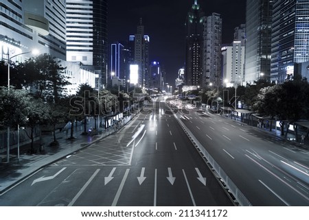 SHENZHEN, CHINA - JULY 14 : Hi-rise building and vehicles commute at night time on July 14,2014 in Shenzhen, China. Shenzhen is China's financial center and first's special economic zone.