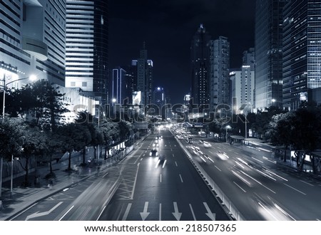 SHENZHEN, CHINA - JULY 14 : Hi-rise building and vehicles commute at night time on July 14,2014 in Shenzhen, China. Shenzhen is China\'s financial center and first\'s special economic zone.