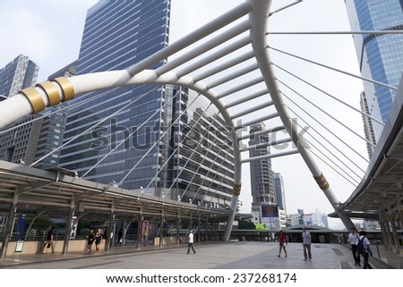 SATHORN ROAD, BANGKOK - NOV 21, 2014: High-Rise buildings and a sky walk at Sathorn-Narathiwas intersection in Bangkok,Thailand. Sky walk is the connecting walkway between sky train and rapid bus.