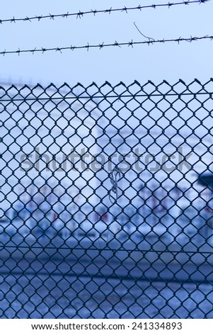 Wire fence of oil tank refinery,focus at the fence.