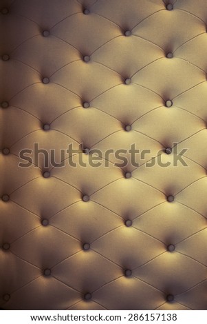 Luxury style background of an old retro sofa with buttons