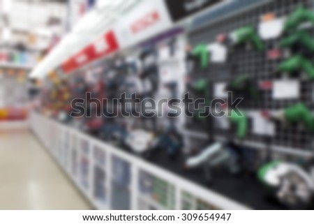 Power tools aisle in hardware store, blurred image