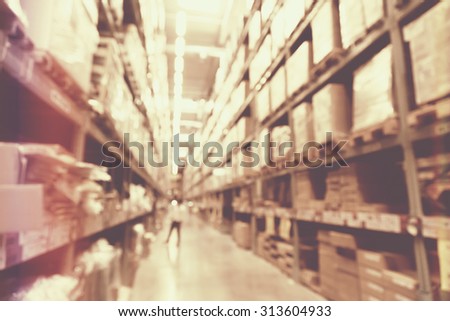 blurred image of boxes in factory warehouse with light leak filter.