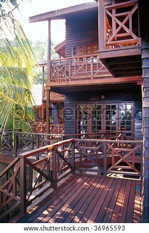 view of wooden terrace with a beautiful wooden house in the background