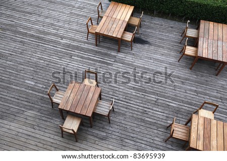 Dining wooden table with wicker chairs in the outdoors. top view
