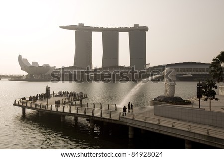 SINGAPORE-SEPTEMBER 5:The Merlion fountain spouts water in front of Marina Bay Sand on Sept 5, 2011. It\'s an imaginary creature with head of lion& body of fish and often seen as a symbol of Singapore.