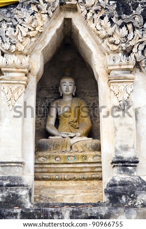 Ancient Buddha statue sitting inside Wat Chedi Liam in Chiang Mai, Thailand