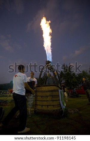 CHIANG MAI - NOV 26: Unidentified pilot testing burner of Hot air balloon during Thailand balloon festival 2011 at Prince Royal college in Chiang mai, Thailand on Nov 26, 2011.