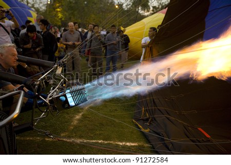 CHIANG MAI - NOV 26: Unidentified man fills hot air in balloon during Thailand balloon festival 2011 at Prince Royal college in Chiang mai, Thailand on Nov 26, 2011.