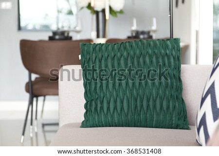 graphic green pillows setting on sofa at comfortable living corner
