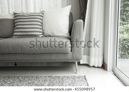 Detail of modern living room with beige pillow cushions on sofa