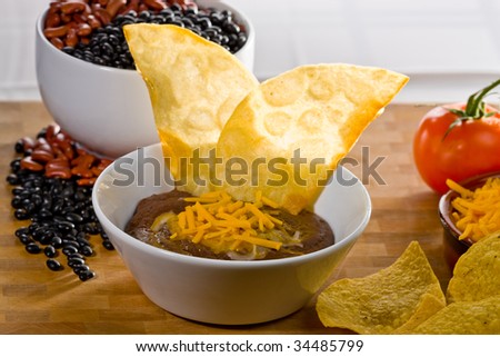 Refried beans with tortilla chips and cheese