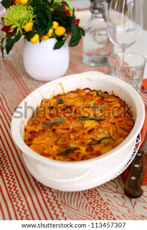 Roasted potatoes with smoked paprika and sage in a white dish