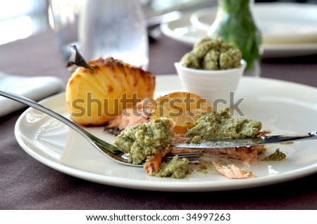 Baked Salmon with potatoes and salsa from the celery and green olives