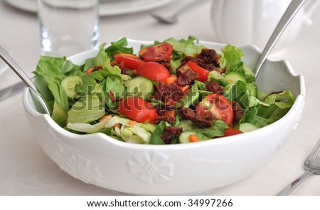 Tomato, Cucumber salad with sun-dried tomatos in white dich
