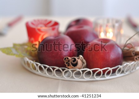 Still Life with apple, cinnamon sticks and candles