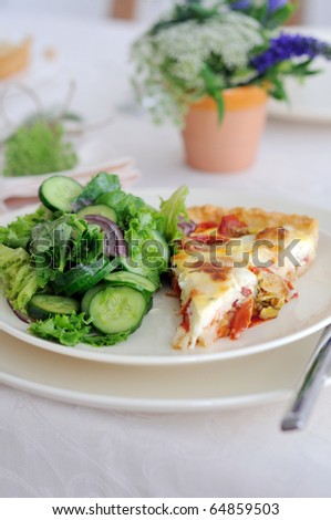 Piece of tomato  cheese pie  and cucumber salad