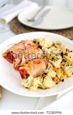 Stuffed bacon and chicken rolls with roasted pepper. Roasted cauliflower