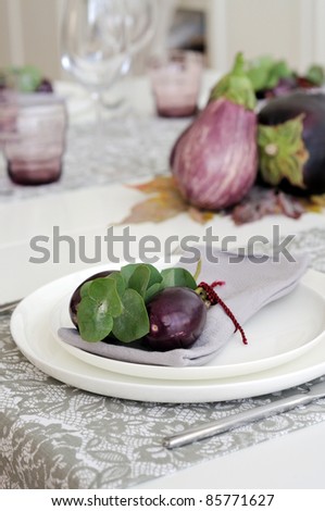 Place setting with aubergine for casual dining