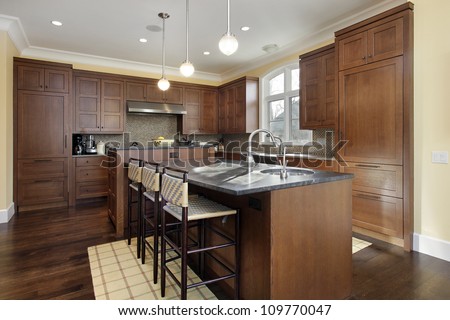 Kitchen In Luxury Home With Oak Wood Cabinetry