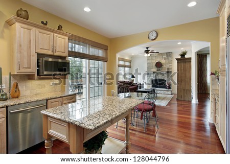 Kitchen in luxury home with view into family room