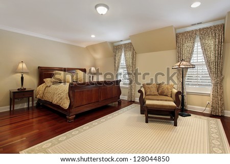 Master Bedroom In Luxury Home With Cherry Wood Flooring