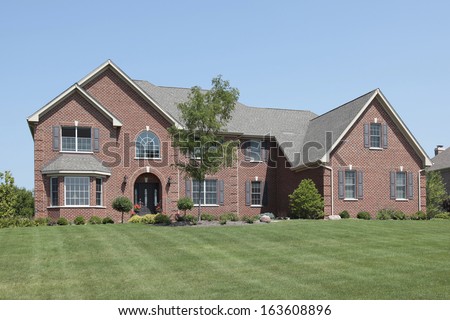 Large brick home with arched entry