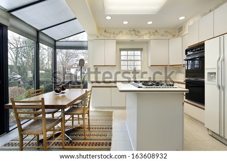 Kitchen With Island And Sliding Doors To Patio