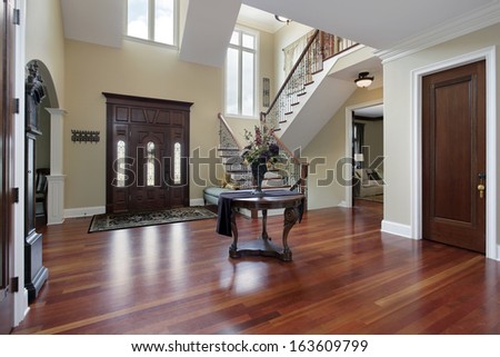 Foyer In Luxury Home With Cherry Wood Flooring