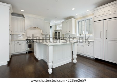 Kitchen in new construction home with white cabinetry