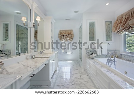 Master bath in luxury home with marble counters