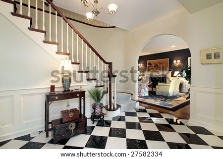 Checkerboard floor in foyer with stairway
