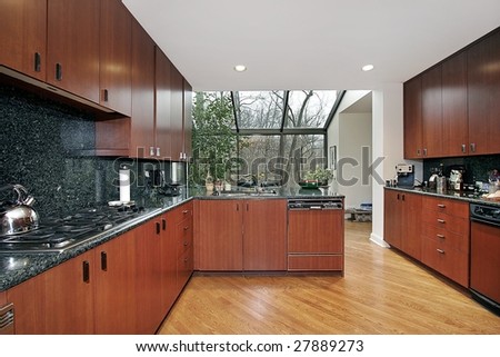 Cherry wood kitchen with greenhouse-type eating area