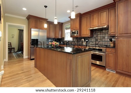 Kitchen in new construction home with wood cabinetry