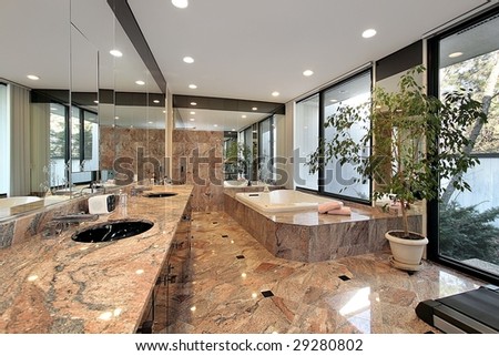 Modern master bath with marble floor and tub