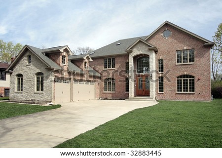 New construction brick home with stone entryway