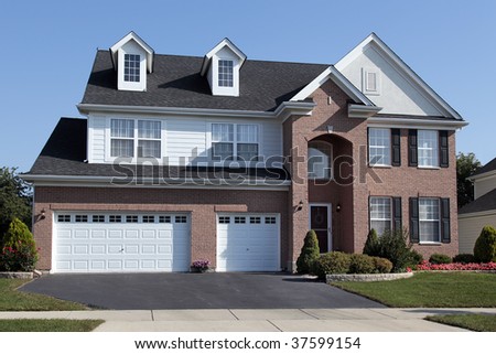 Brick home in suburbs with arched doorway
