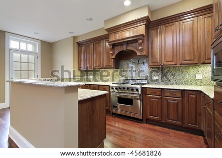Kitchen in new construction home with granite backsplash