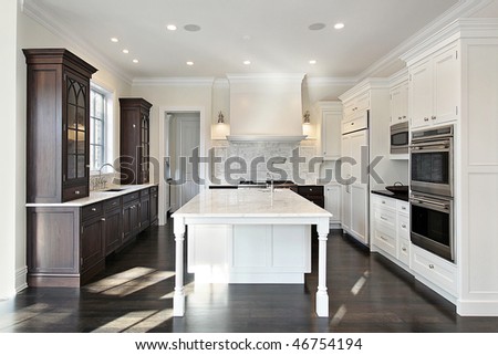 Kitchen in new construction home with dark and light wood cabinetry
