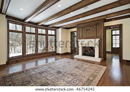 Family room in new construction home with wood ceiling beams
