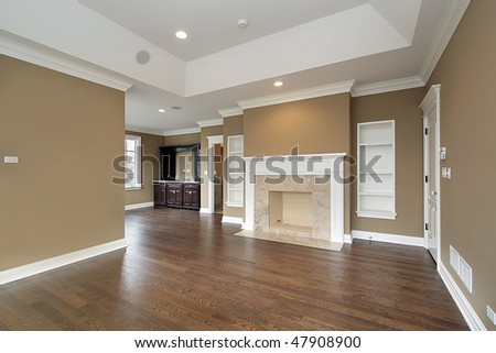 Master bedroom in new construction home with marble fireplace