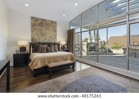 Master bedroom in luxury home with large deck