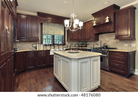 Kitchen in luxury home with white and granite island