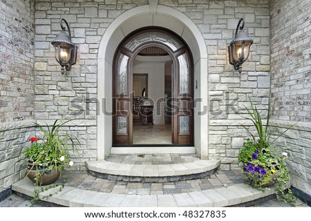 Arched stone entry of luxury suburban home