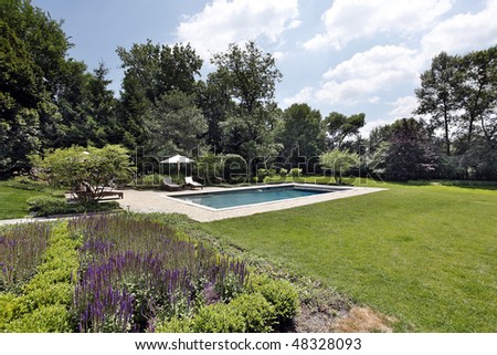 Swimming pool with brick deck and flowers