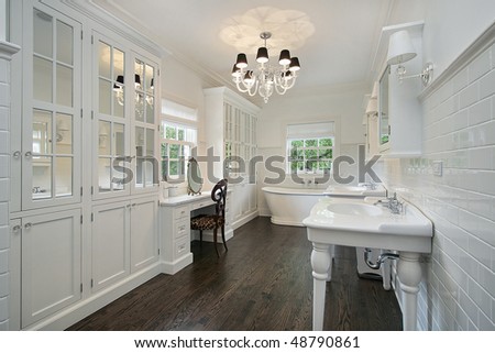 White master bath with dark wood floors